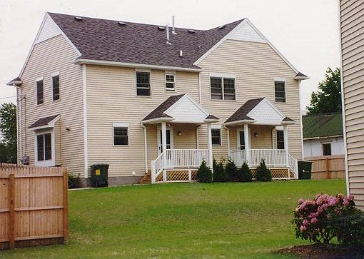 a white house with a wooden fence